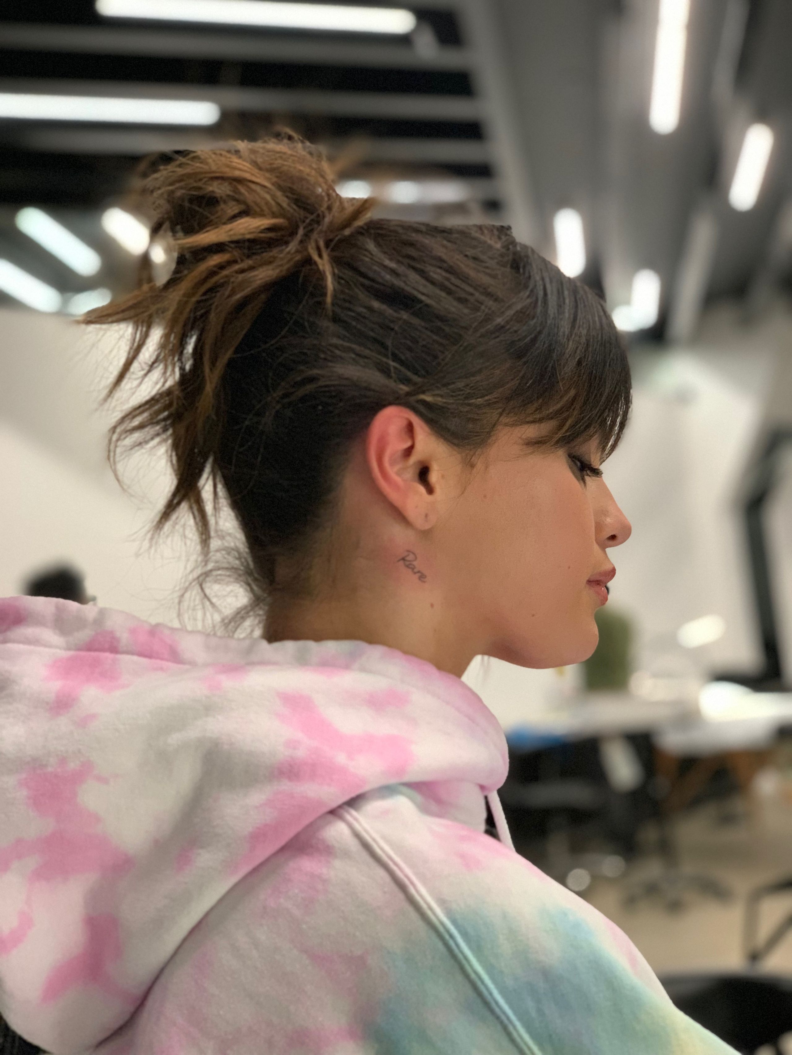 Source photo of Selena Gomez in profile, with the small cursive word Rare visible below her right ear