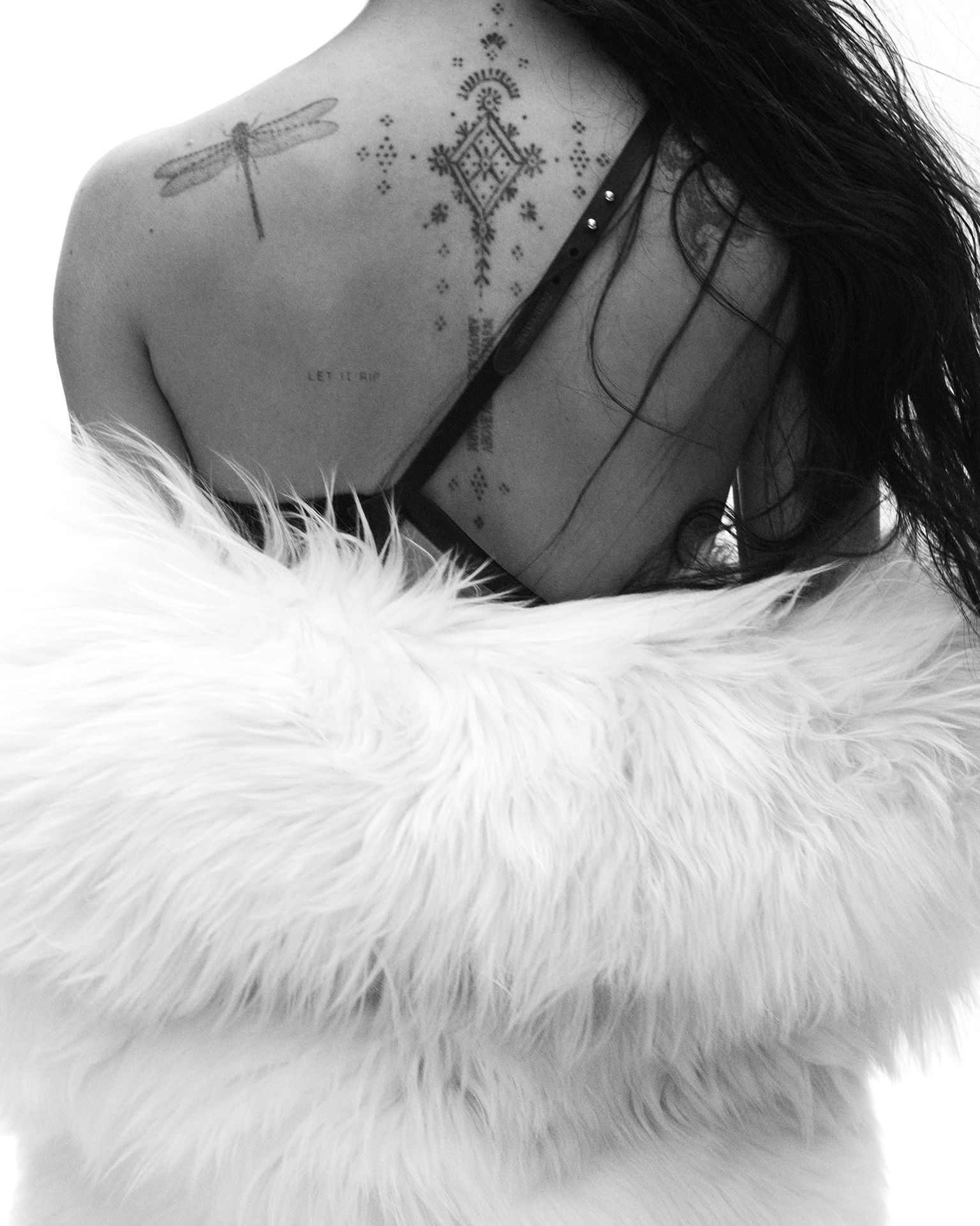Source photo from British Vogue showing Zoë Kravitz’s upper back and the visible Let It Rip tattoo